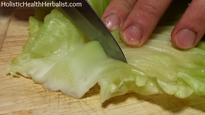 trimming the core from the cabbage leaves